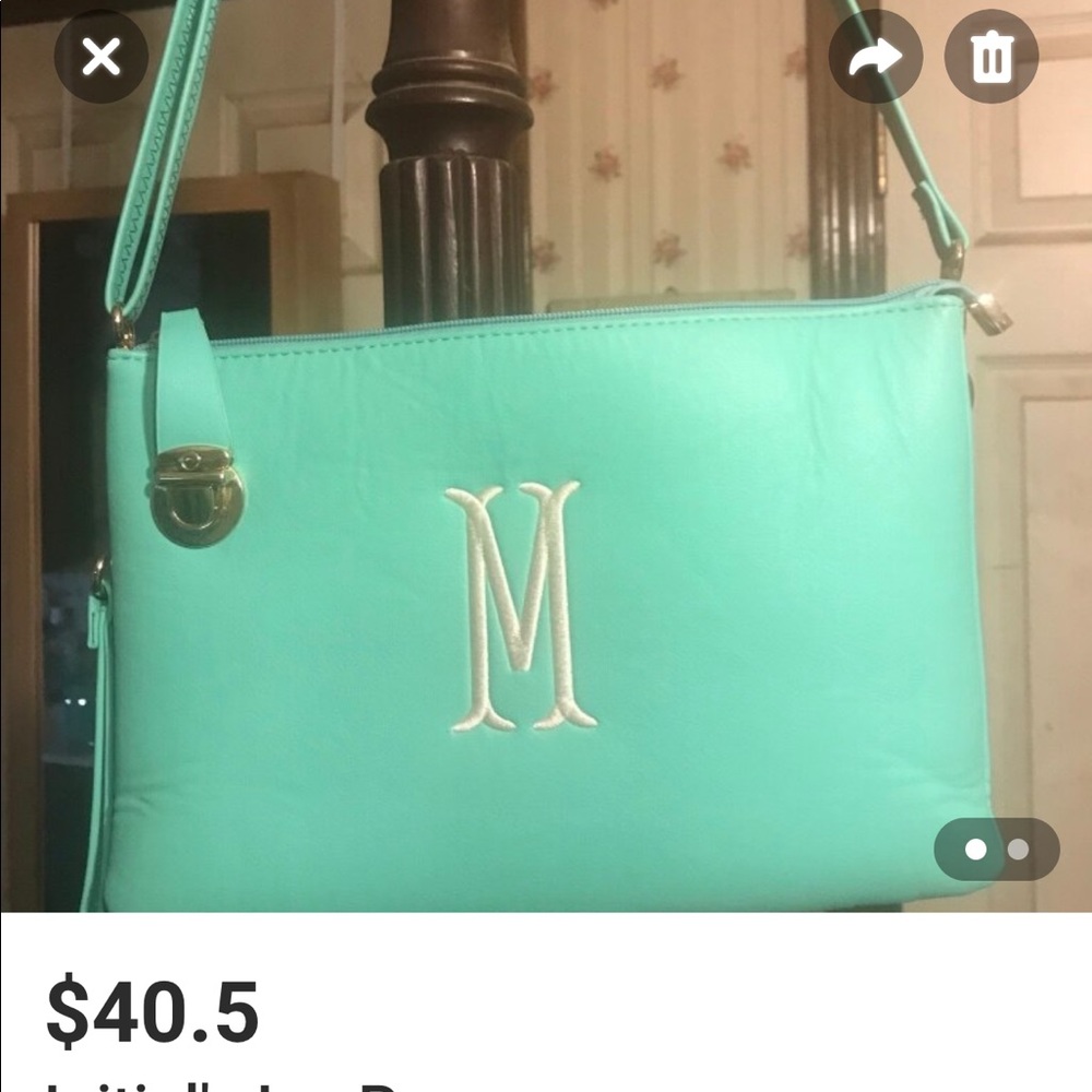 Excellent condition Initial’s Inc aqua color purse. Used once.